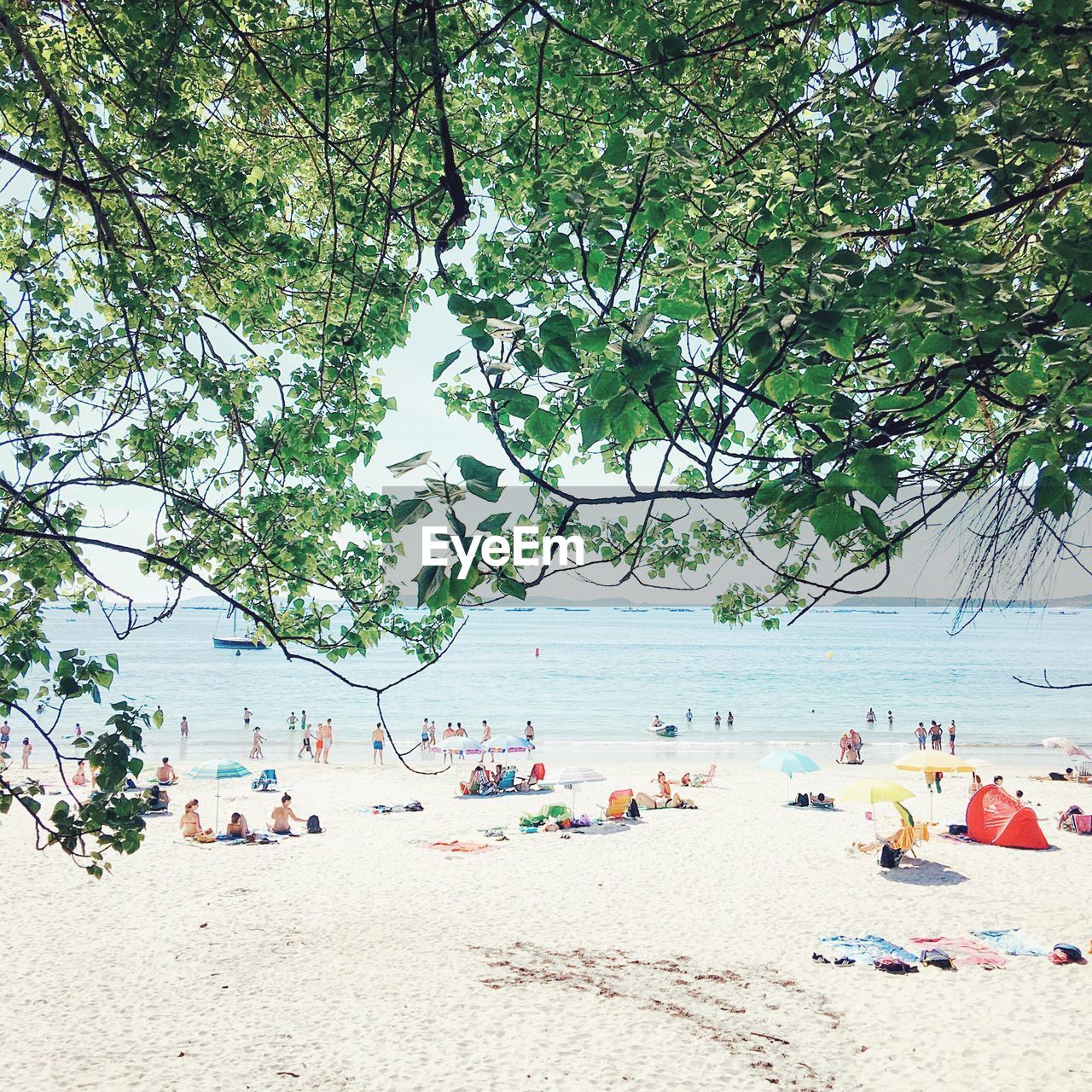 People at beach against sky