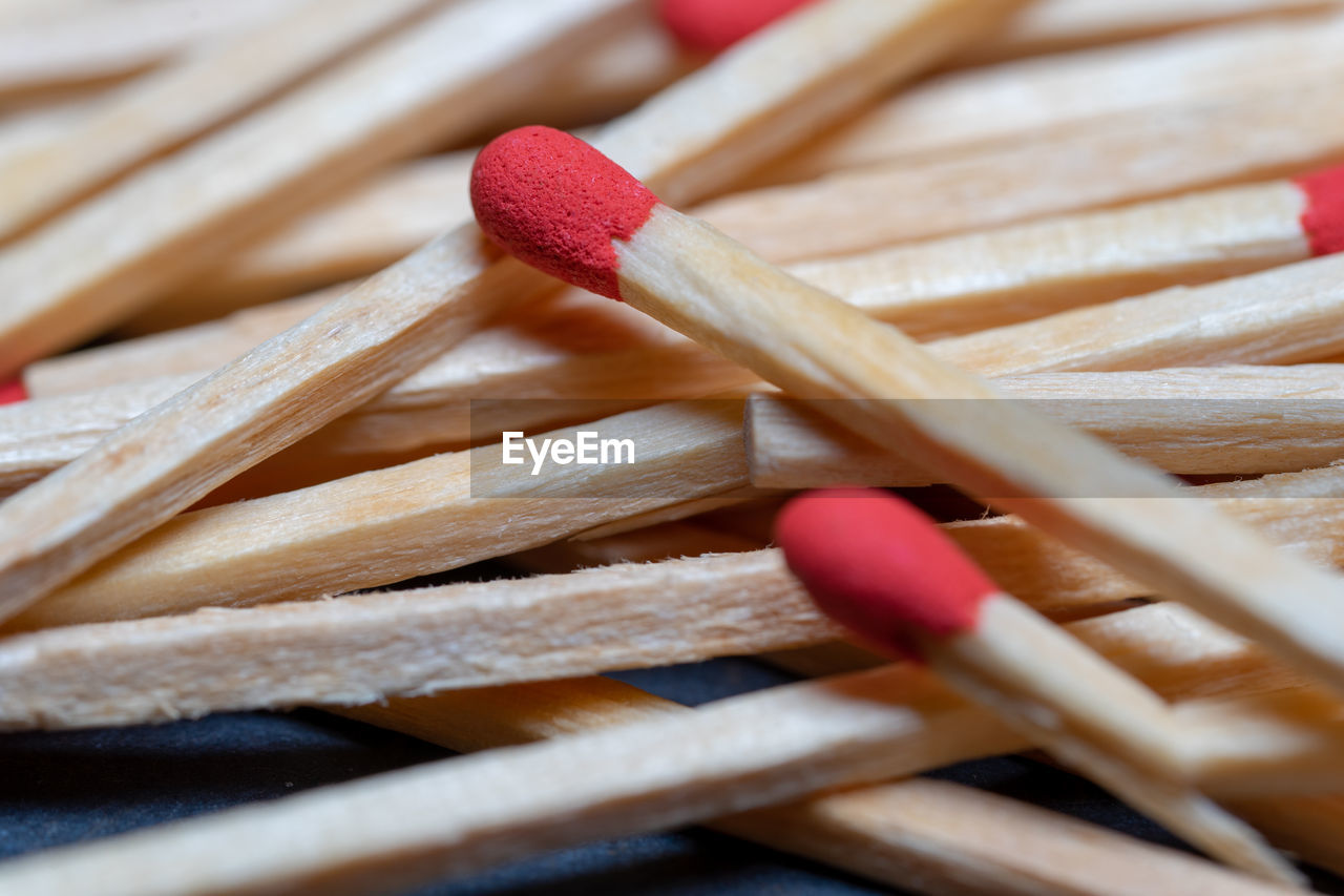 Set of red-headed phosphor sticks piled in a disorganized manner