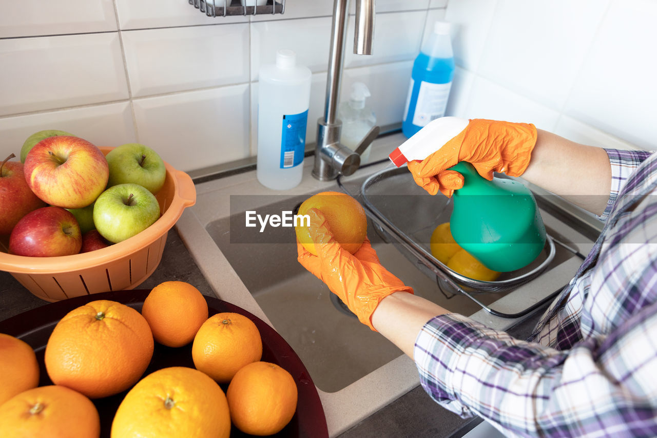 Spraying disinfecting chemical on the fruit in the kitchen