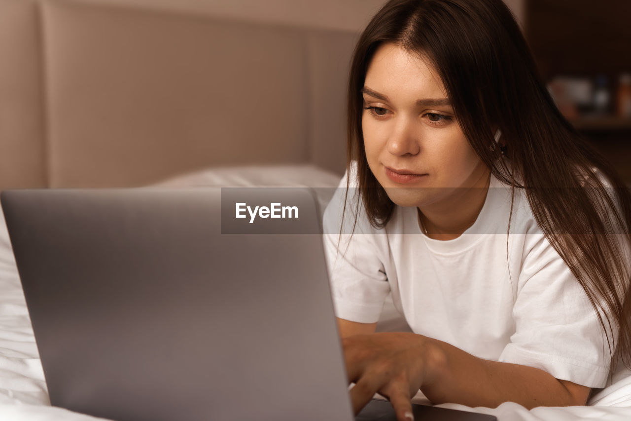 Young woman using laptop at home