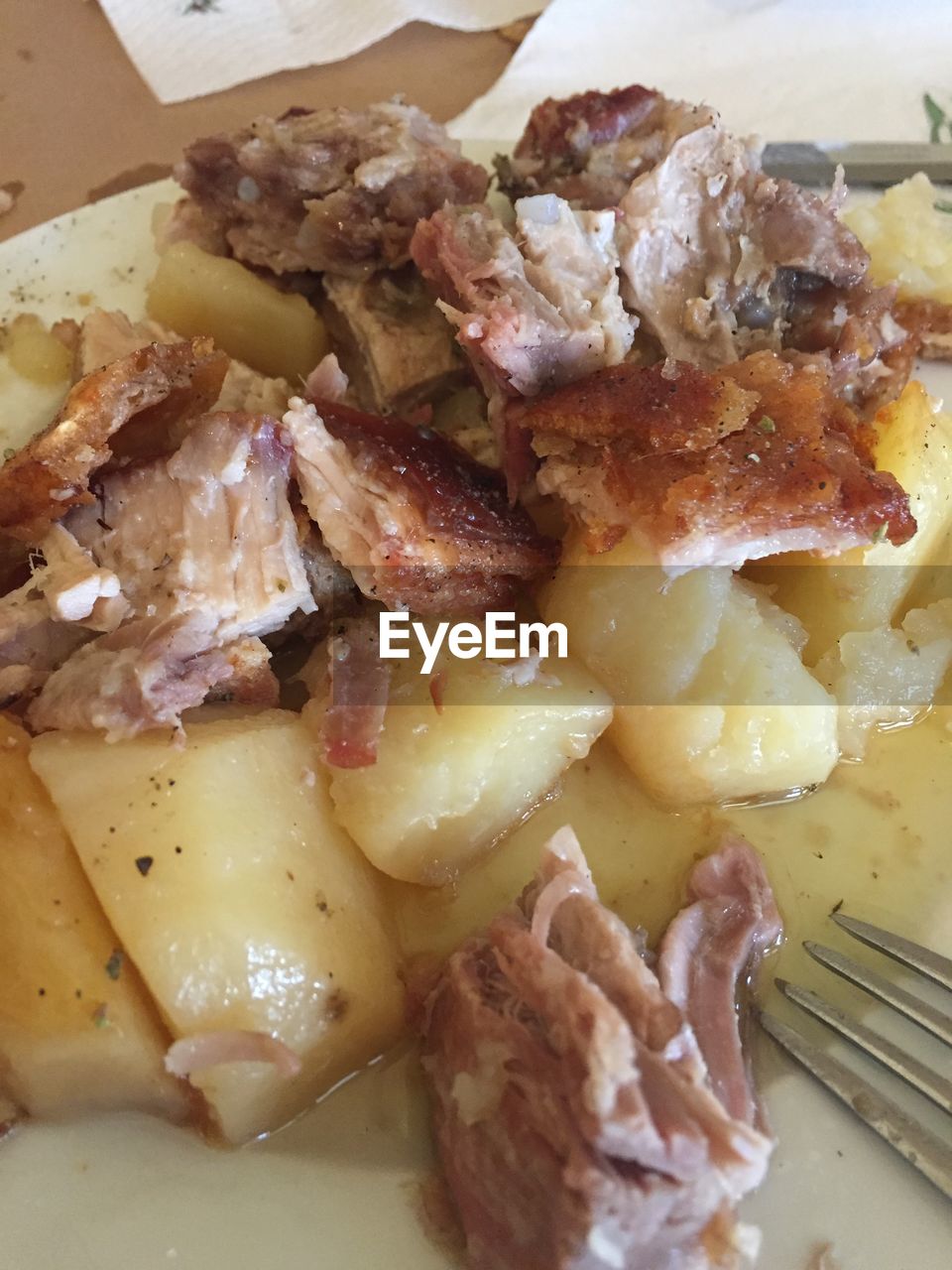 Close-up of meat with prepared potato in plate