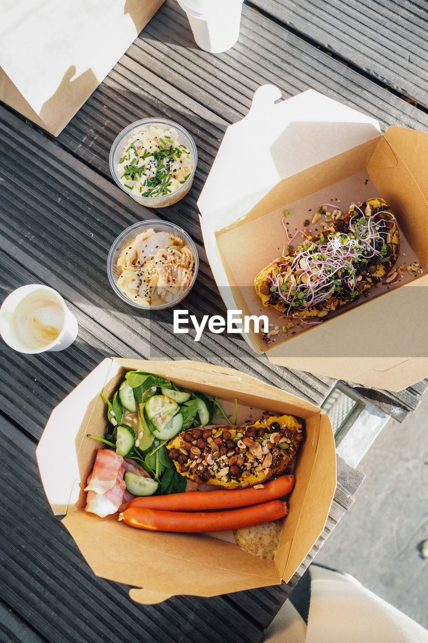 High angle view of food in box outside, take away breakfast.