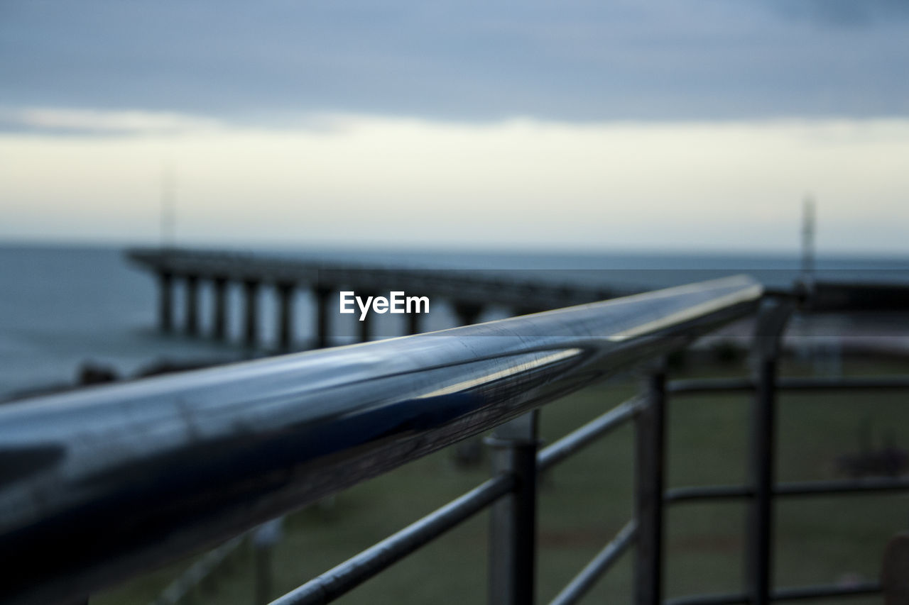 Close-up of railing against sea