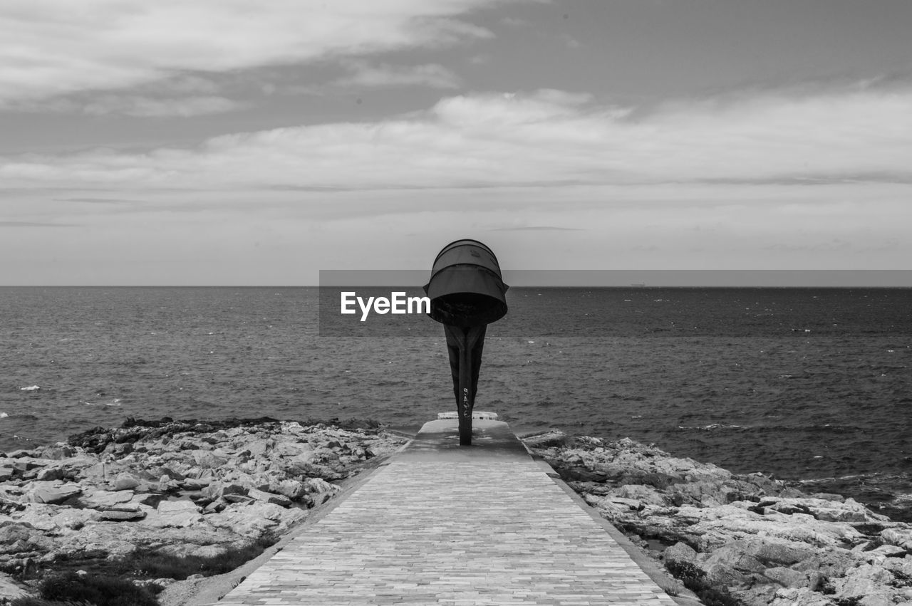 Pier by sea against sky