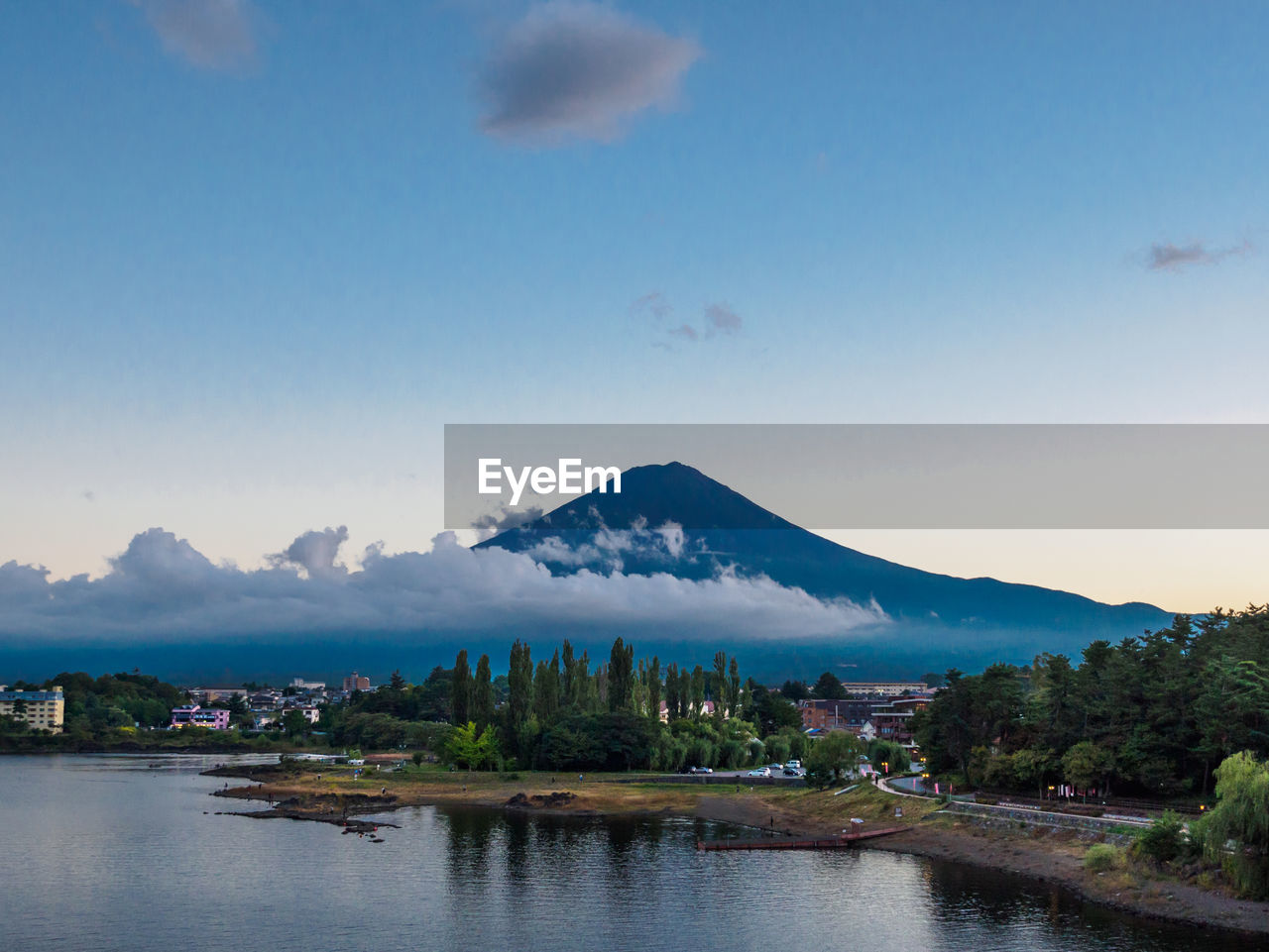 Scenic view of river and mountains against sky