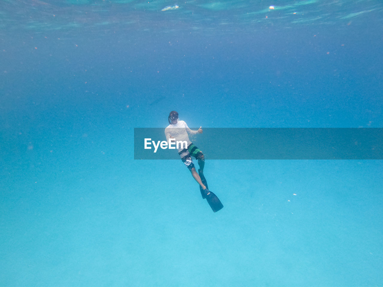 low angle view of man swimming in sea