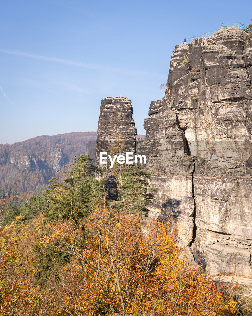 Rock formations on mountain against sky in autumn