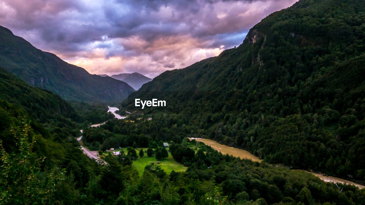 Scenic view of mountains against cloudy sky