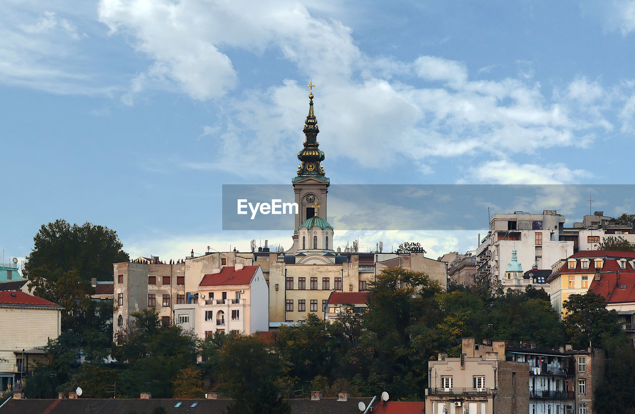 View of buildings and church against sky