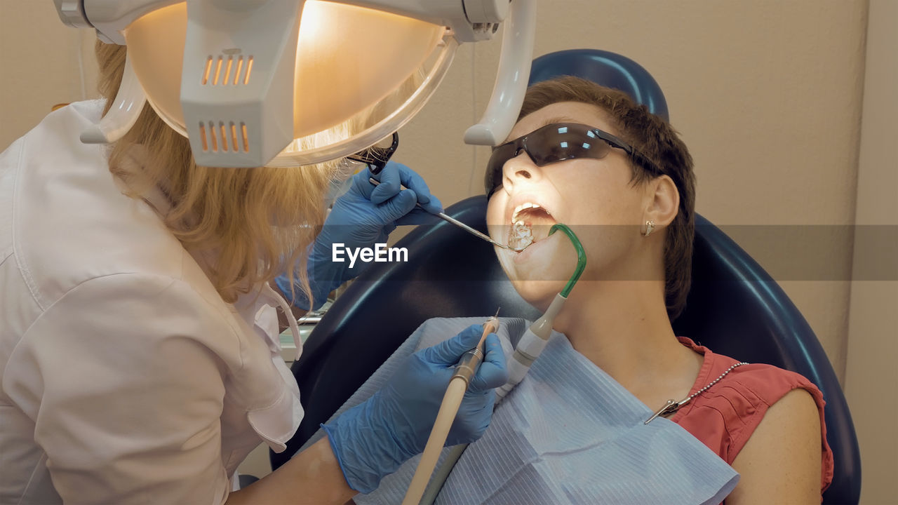 Cropped image of dentist examining patient