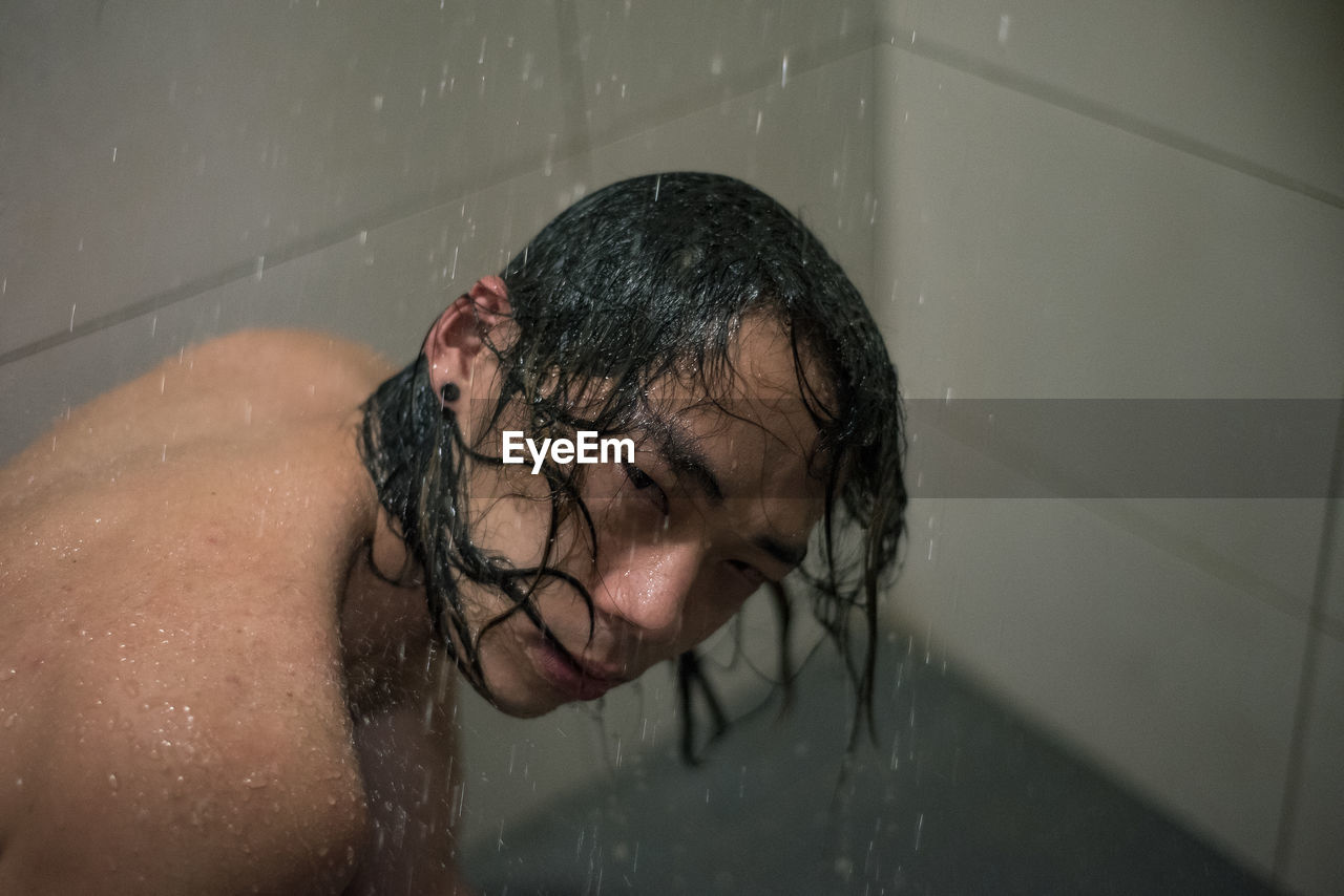 REFLECTION OF MAN IN BATHTUB