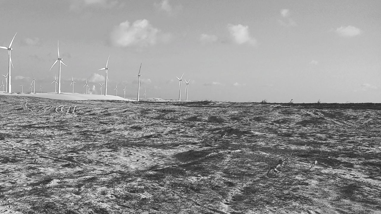 VIEW OF WINDMILL ON FIELD AGAINST SKY