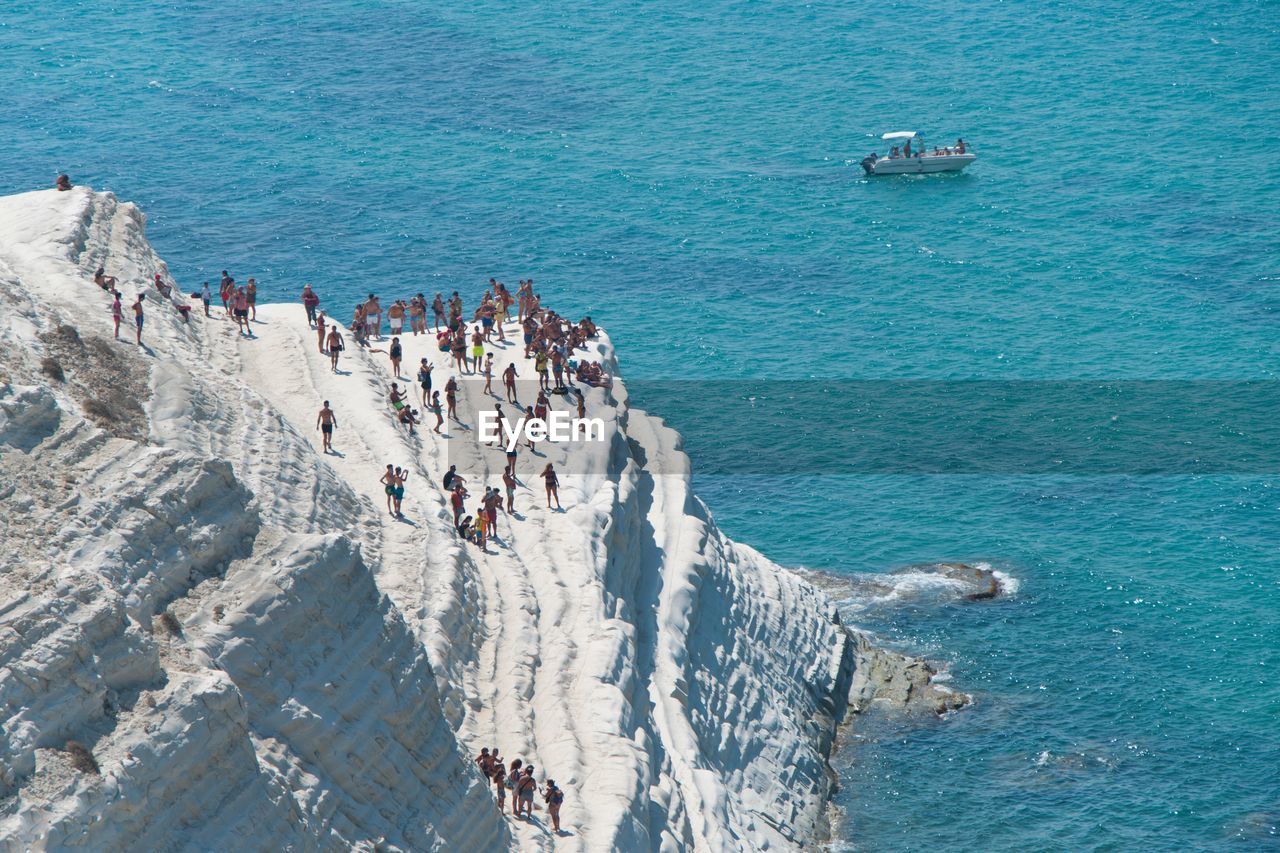 High angle view of people on scala dei turchi by sea