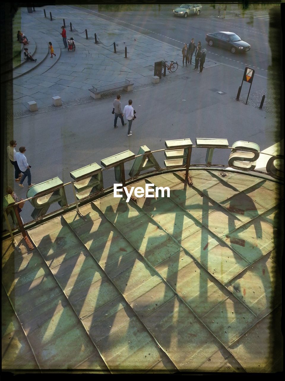 High angle view of text on roof with people on street