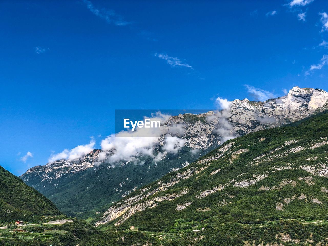 Scenic view of mountains against blue sky