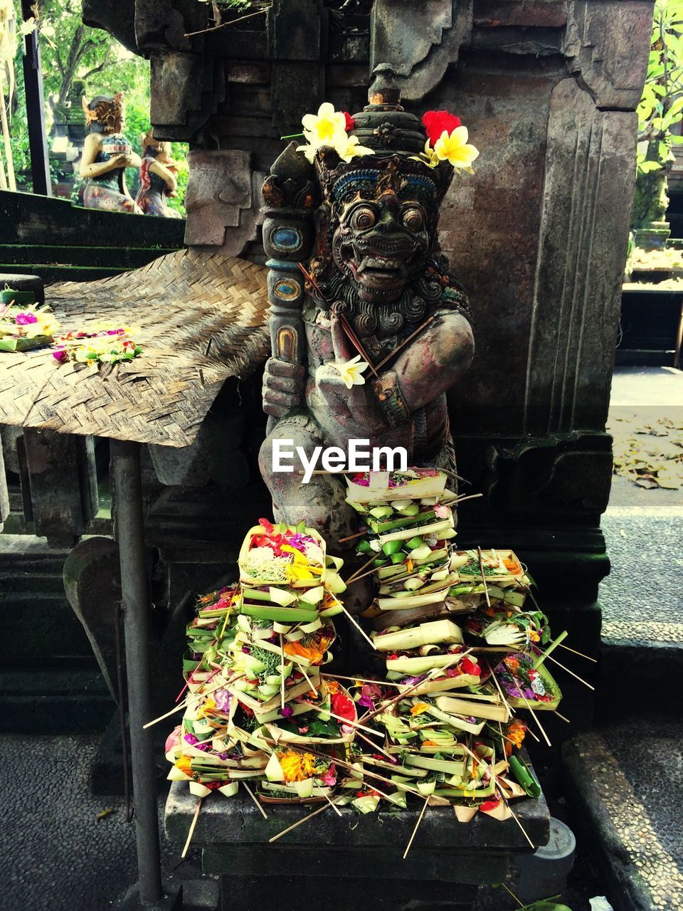 Sculpture with religious offerings