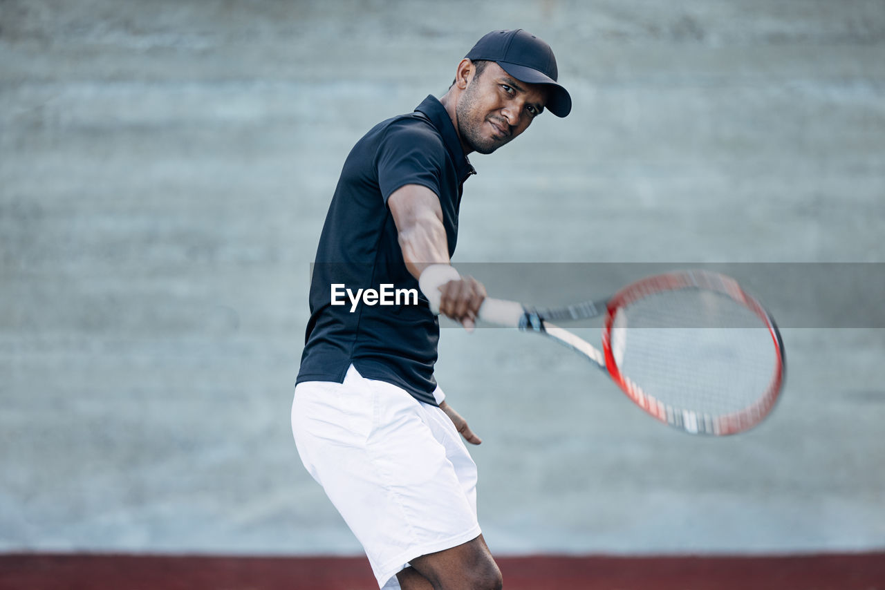 rear view of man playing tennis