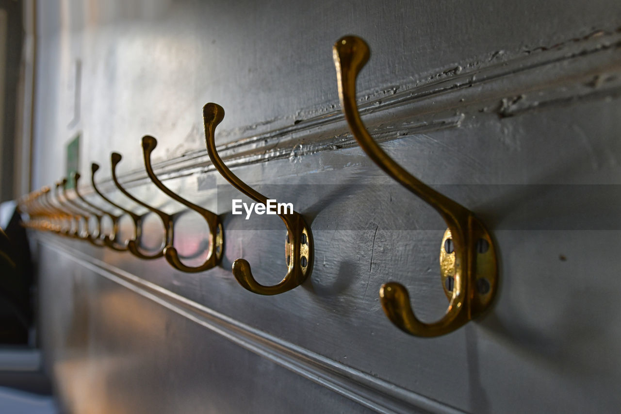 Close-up of hooks mounted on wall at home