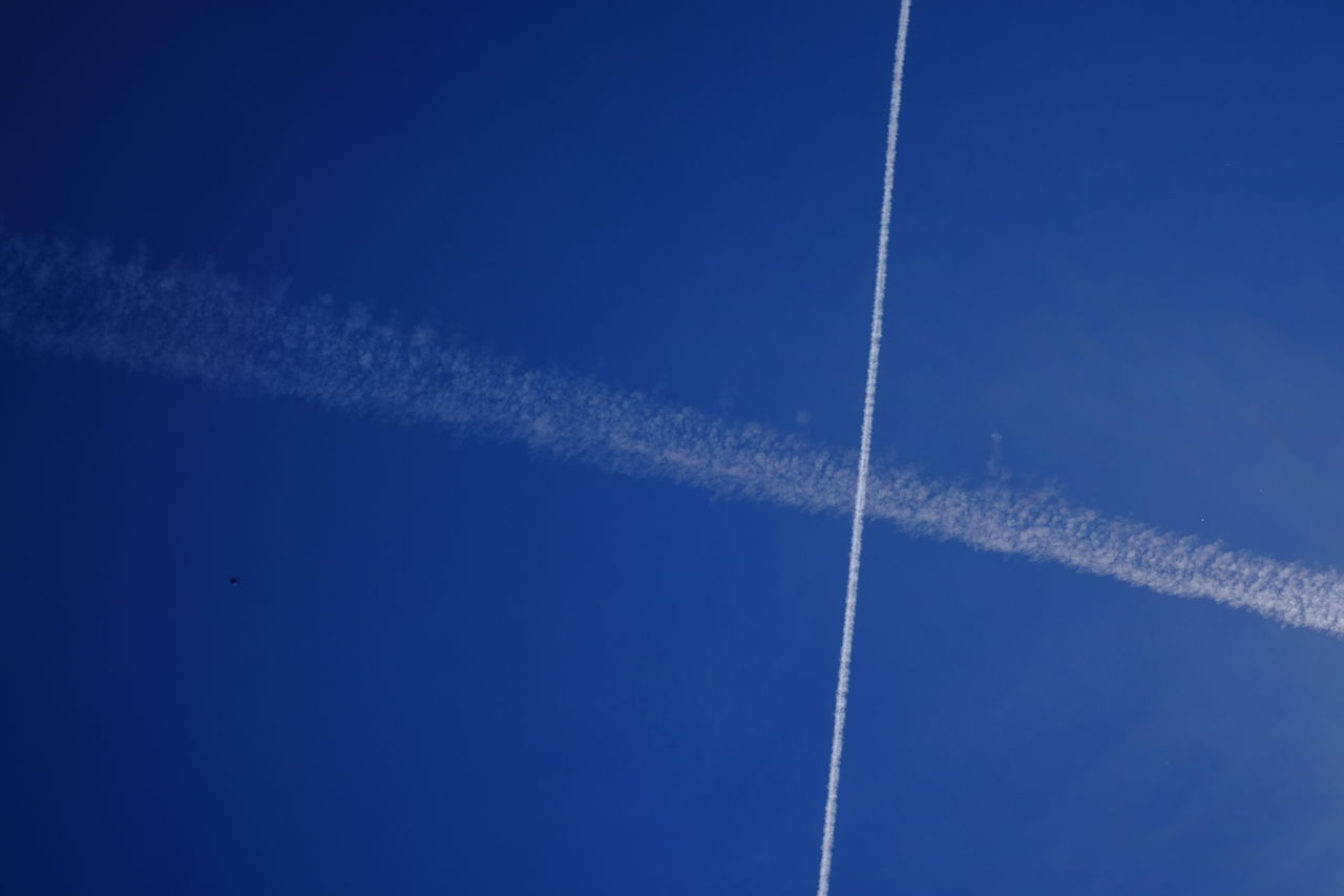 Low angle view of vapor trail against clear blue sky