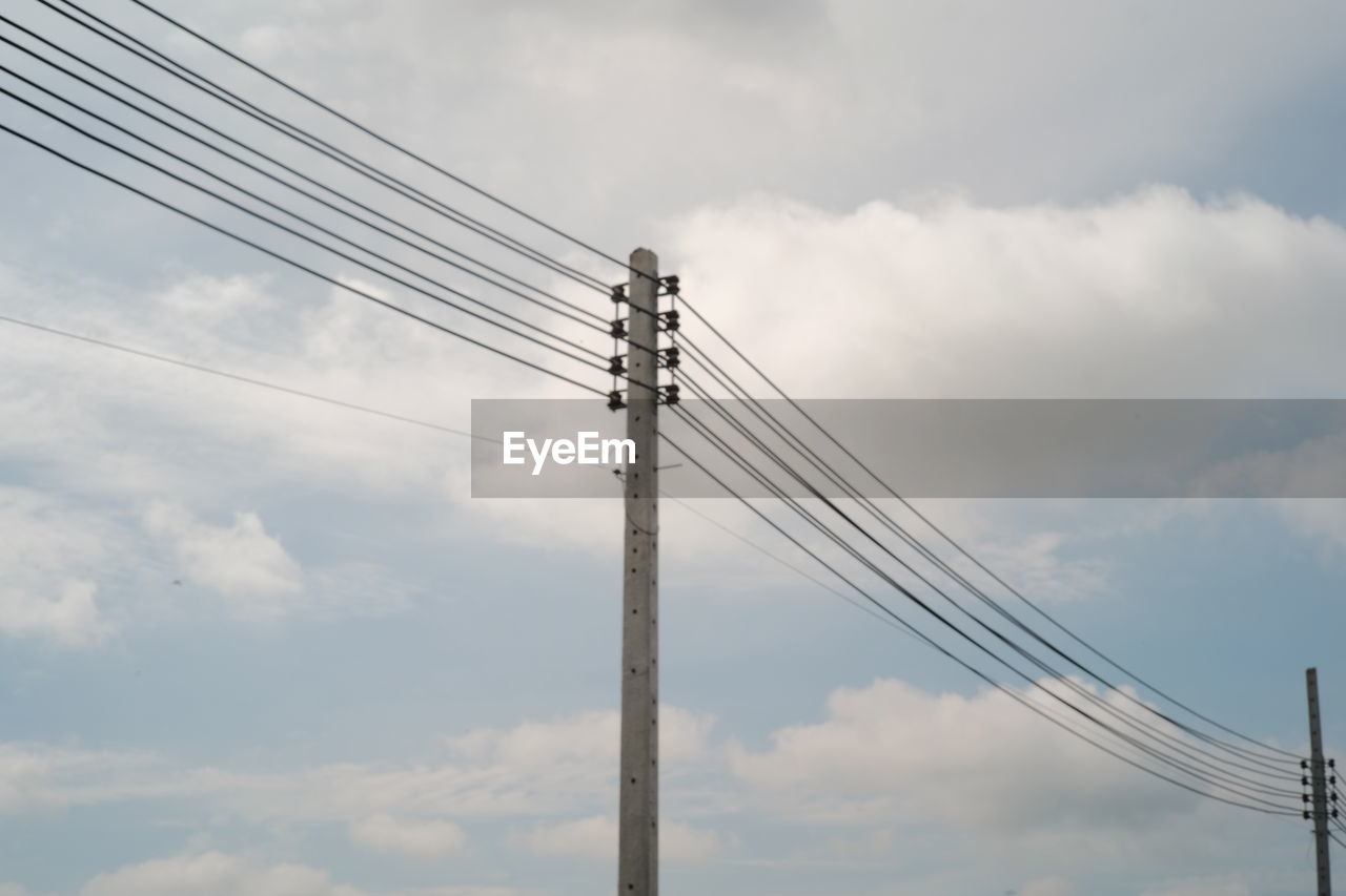 cloud, cable, sky, electricity, technology, power supply, power line, overhead power line, low angle view, power generation, electricity pylon, nature, mast, line, tower, telephone line, day, no people, outdoors, transmission tower, street light, communication, architecture, pole, wind, electrical supply, built structure, telephone pole, lighting