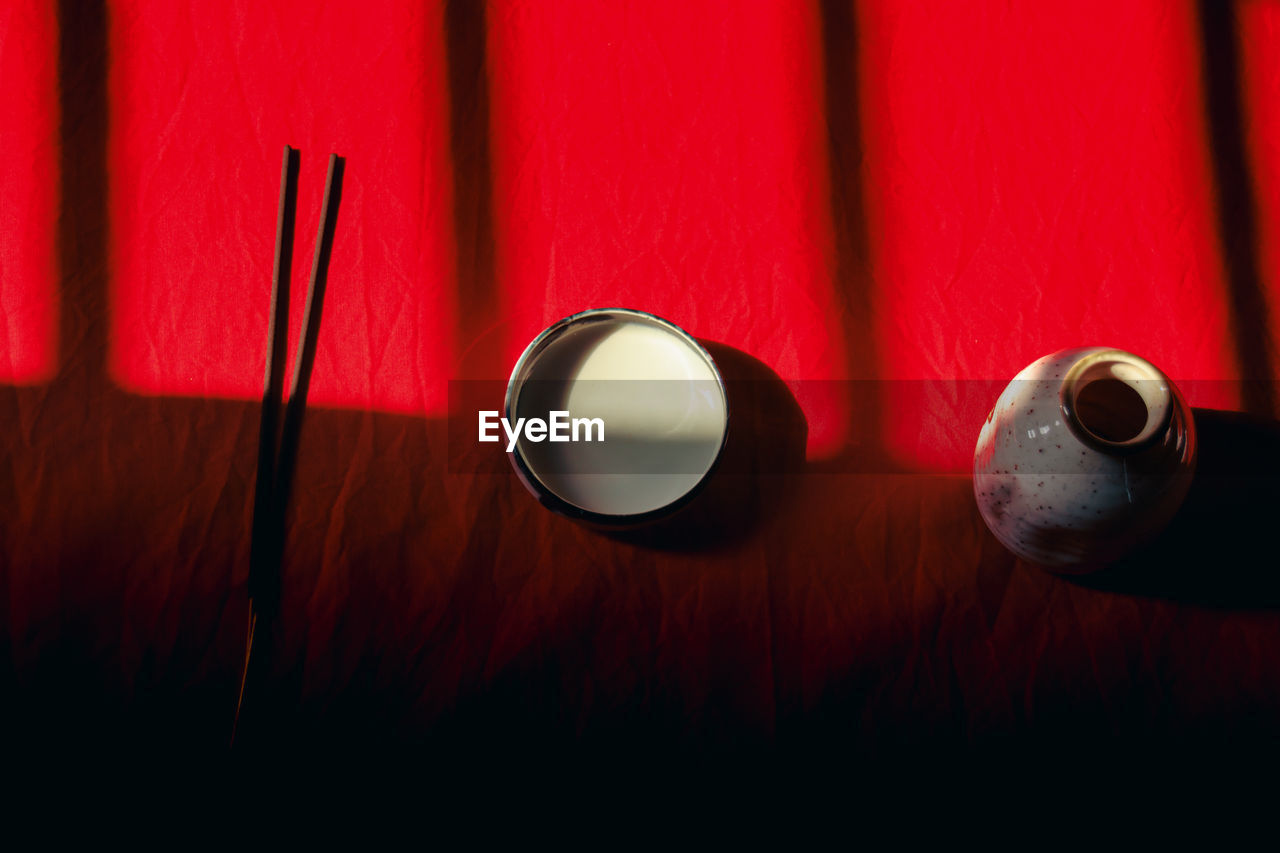 red, indoors, light, no people, darkness, close-up, wood, circle, macro photography, table, lighting