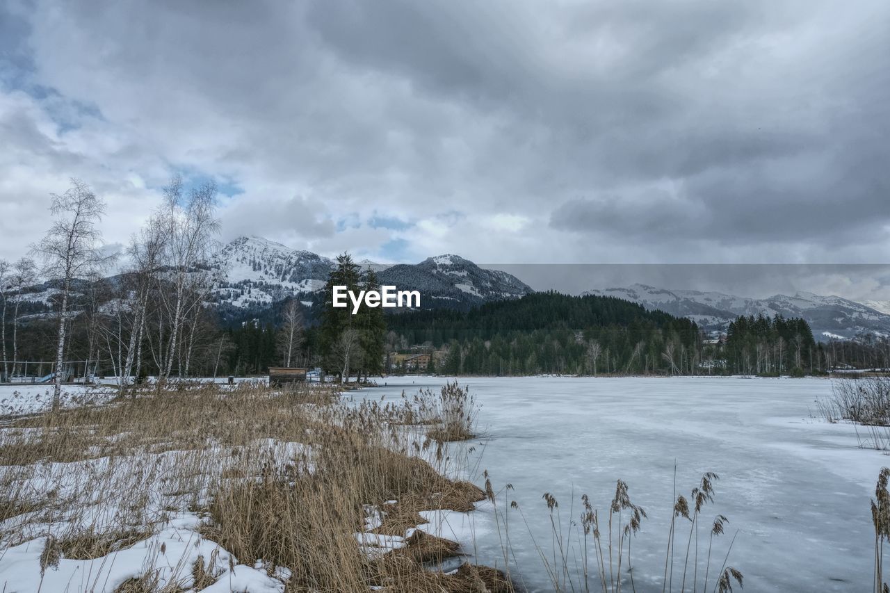 SCENIC VIEW OF SNOWCAPPED MOUNTAINS AGAINST SKY DURING WINTER