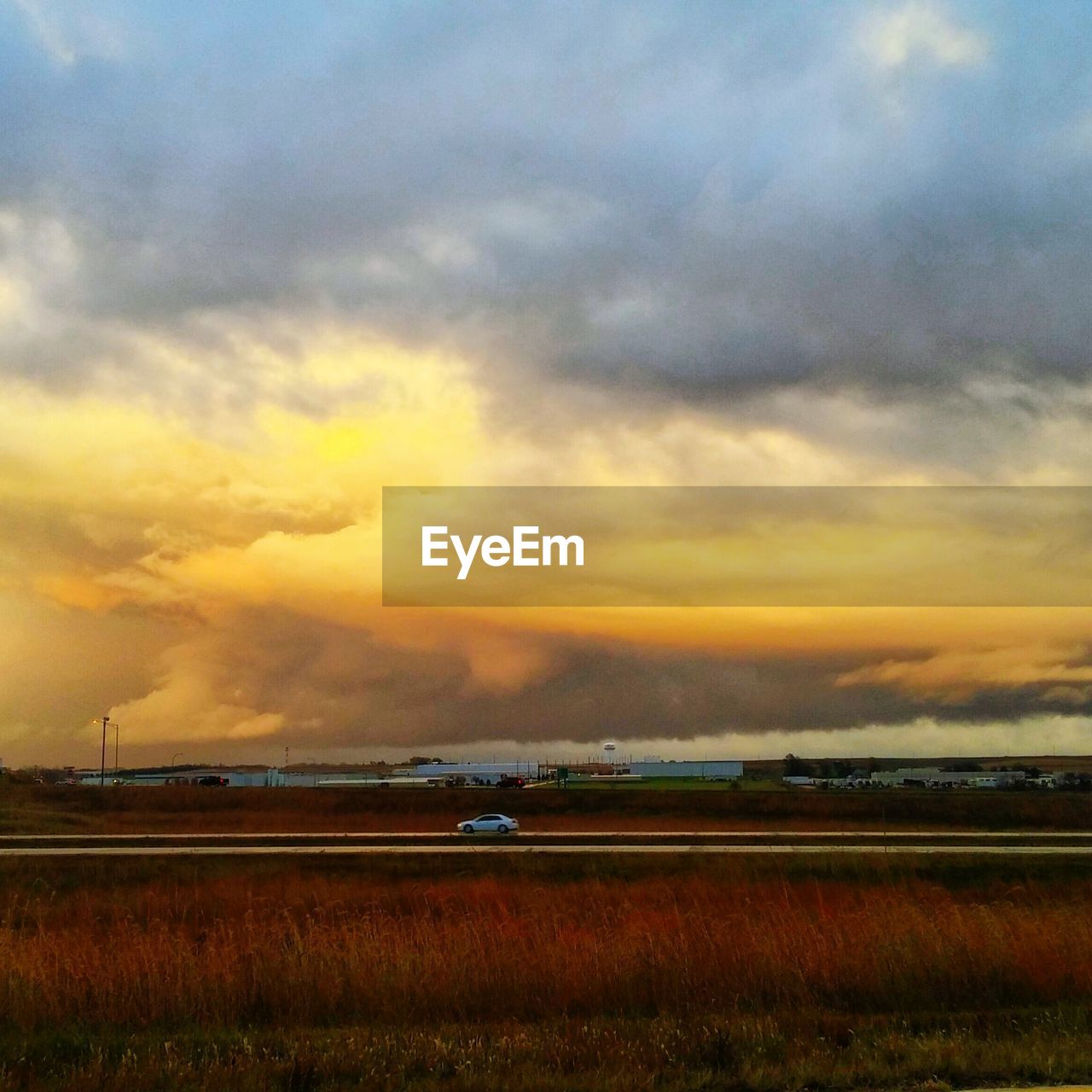 SCENIC VIEW OF DRAMATIC SKY OVER FIELD DURING SUNSET