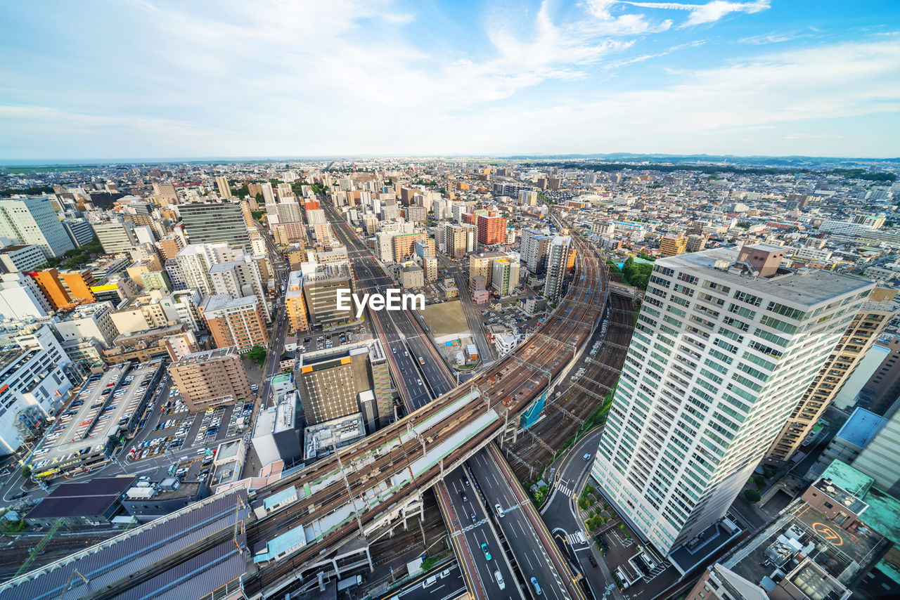 HIGH ANGLE VIEW OF MODERN CITY BUILDINGS AGAINST SKY