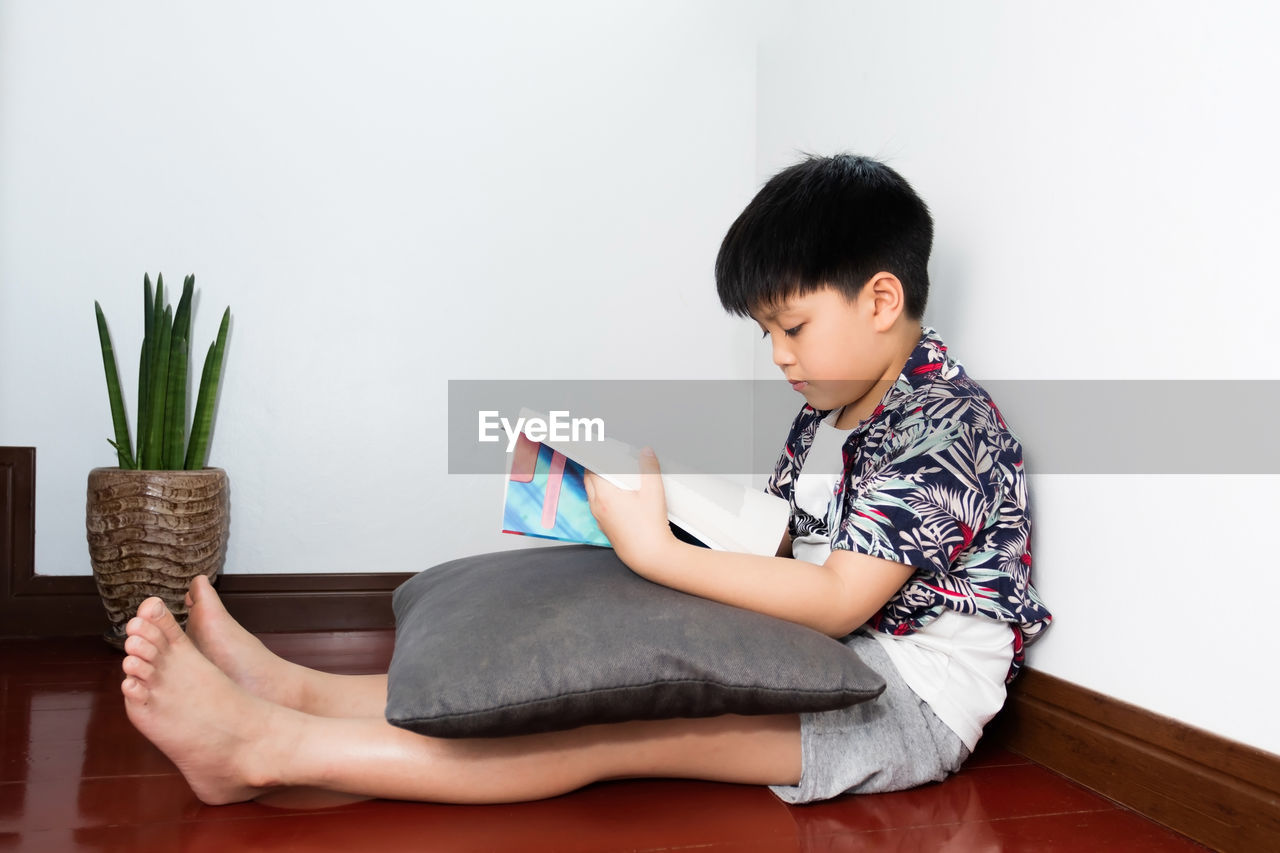 A thai student reading and reviewing lessons at his home. the impact of the covid-19 epidemic.