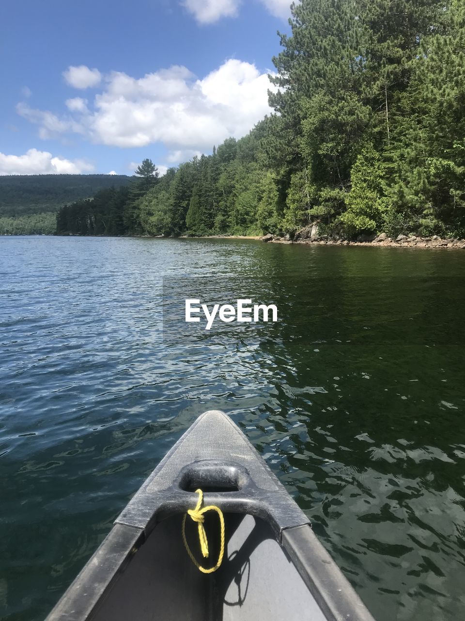 BOAT IN LAKE AGAINST SKY