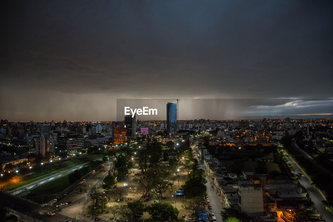 HIGH ANGLE VIEW OF ILLUMINATED BUILDINGS AGAINST SKY