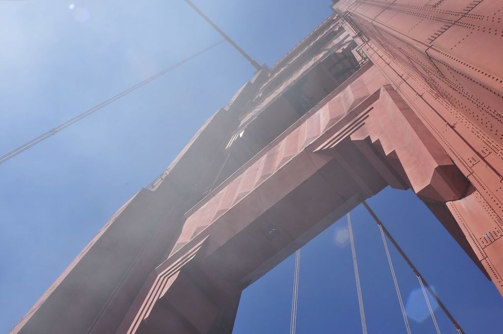 LOW ANGLE VIEW OF MODERN BUILDING AGAINST BLUE SKY