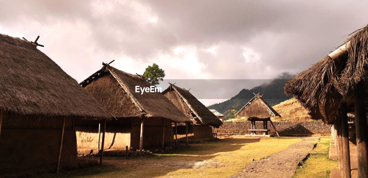 PANORAMIC VIEW OF VILLAGE AGAINST SKY