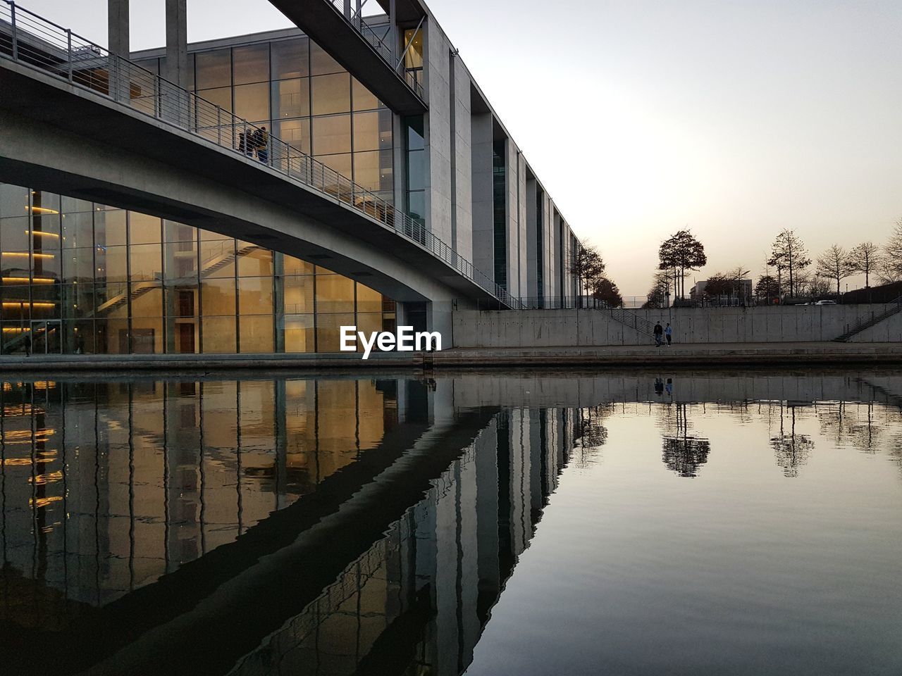 Reflection of building in water against sky