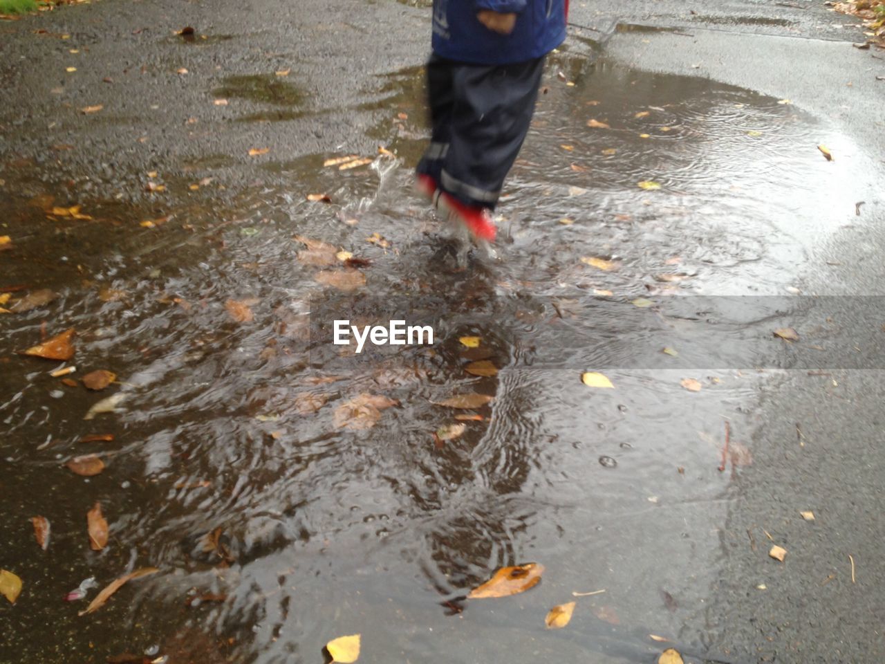 REFLECTION OF PEOPLE IN PUDDLE