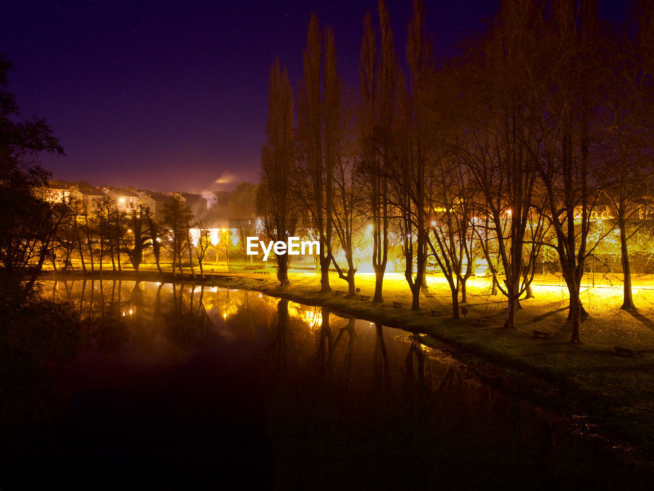 Scenic view of lake against sky at night