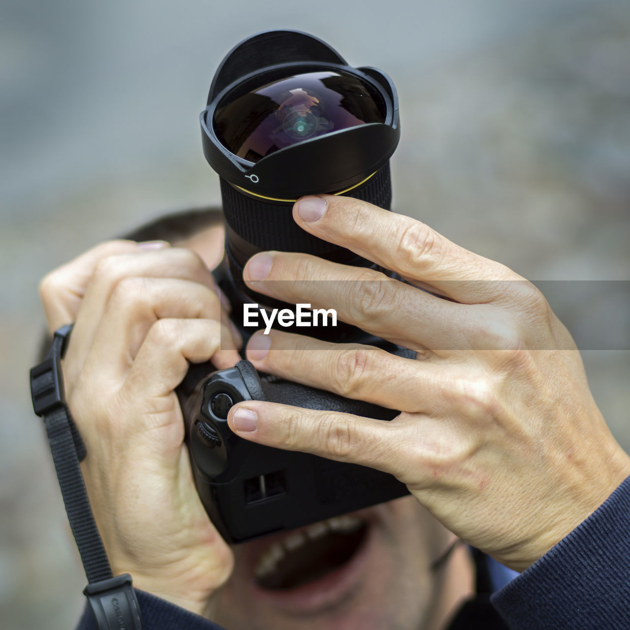 Low angle view of man photographing while standing outdoors