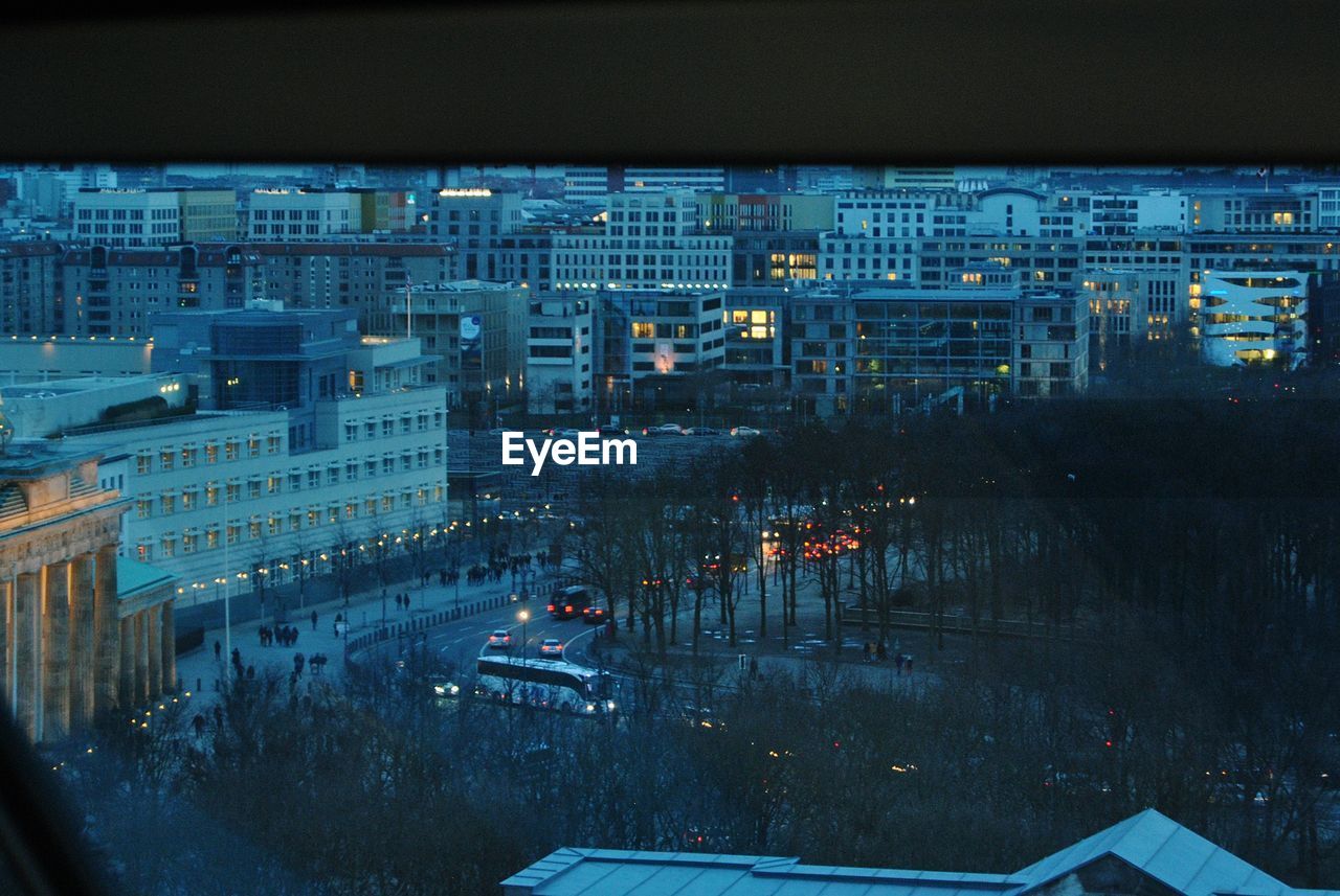 HIGH ANGLE VIEW OF ILLUMINATED CITY AT NIGHT