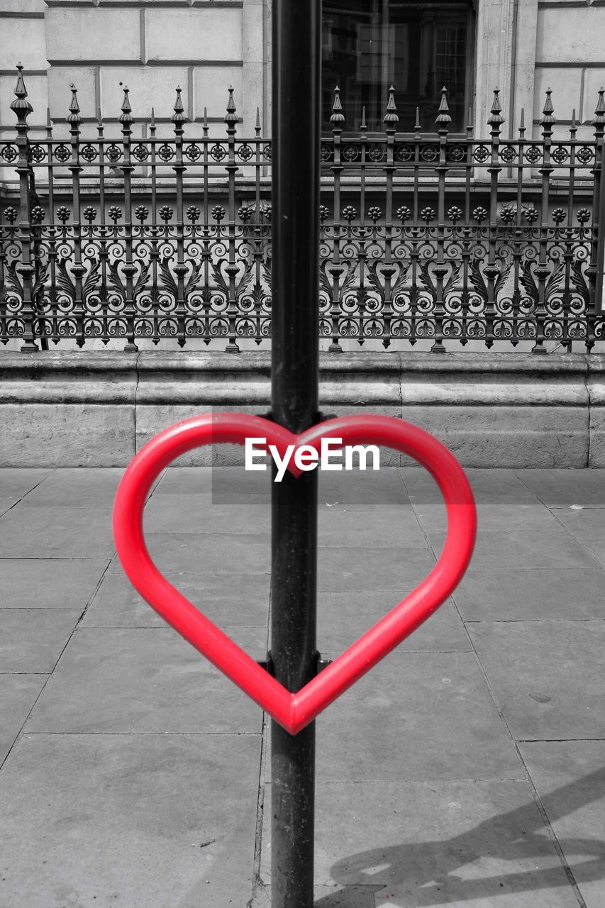 CLOSE-UP OF METAL RAILING AGAINST BUILDING