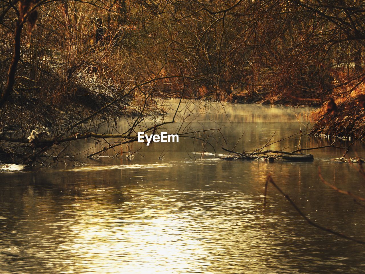 SCENIC VIEW OF LAKE AT SUNSET