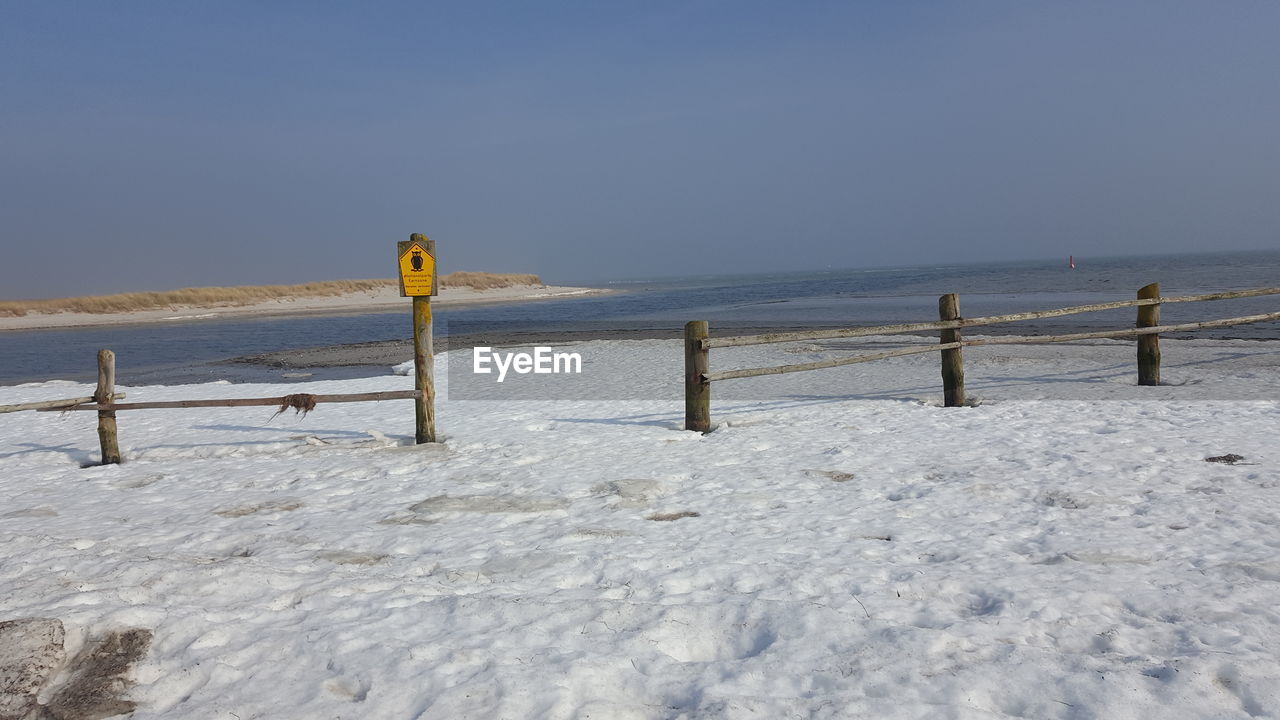 Scenic view of sea against clear sky during winter