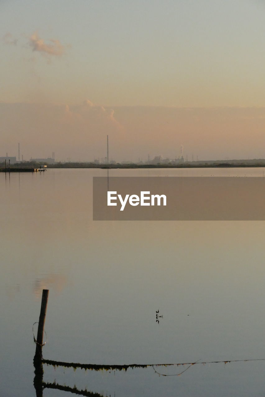 SCENIC VIEW OF LAKE AT SUNSET