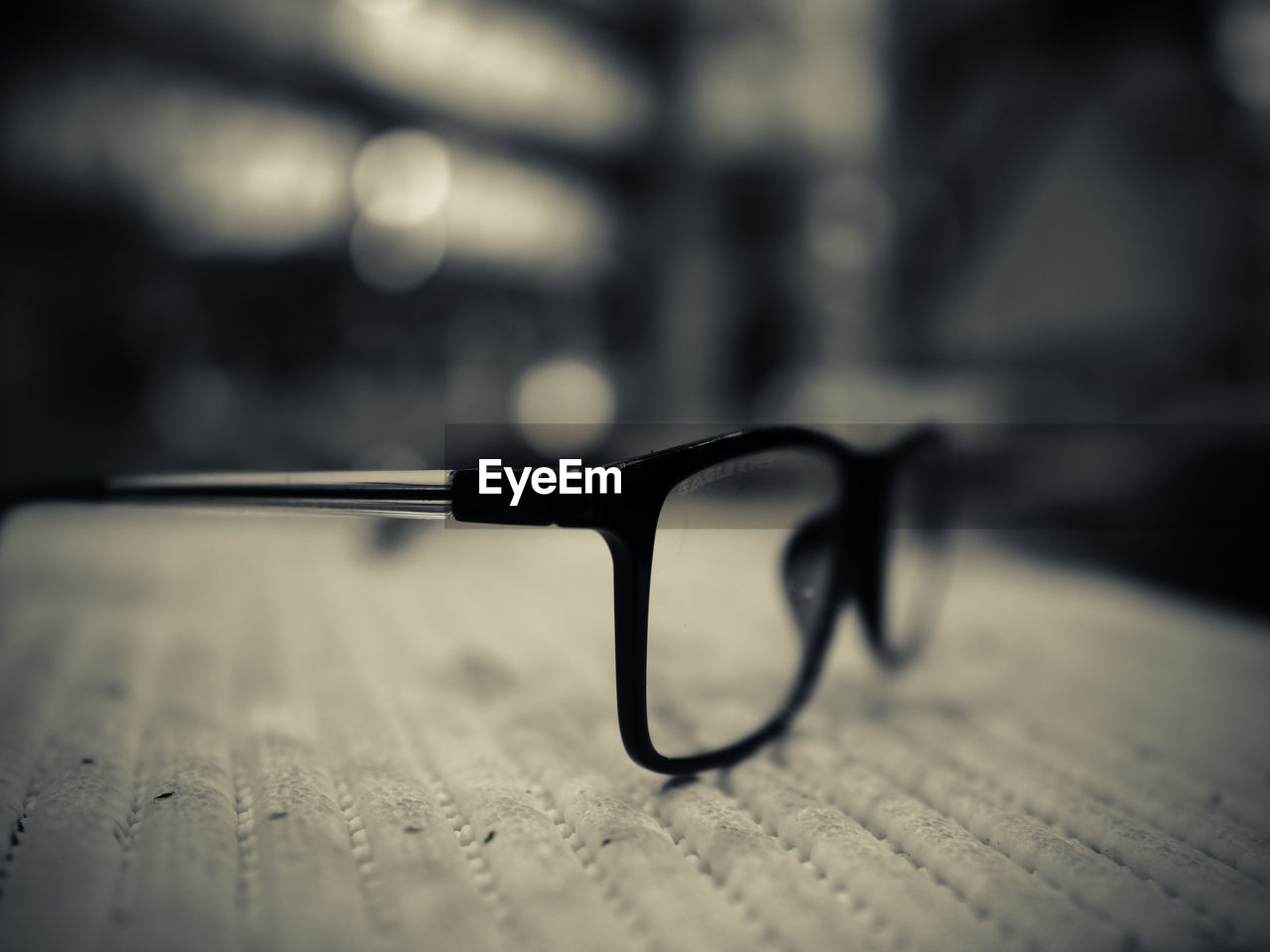 CLOSE-UP OF EYEGLASSES ON TABLE