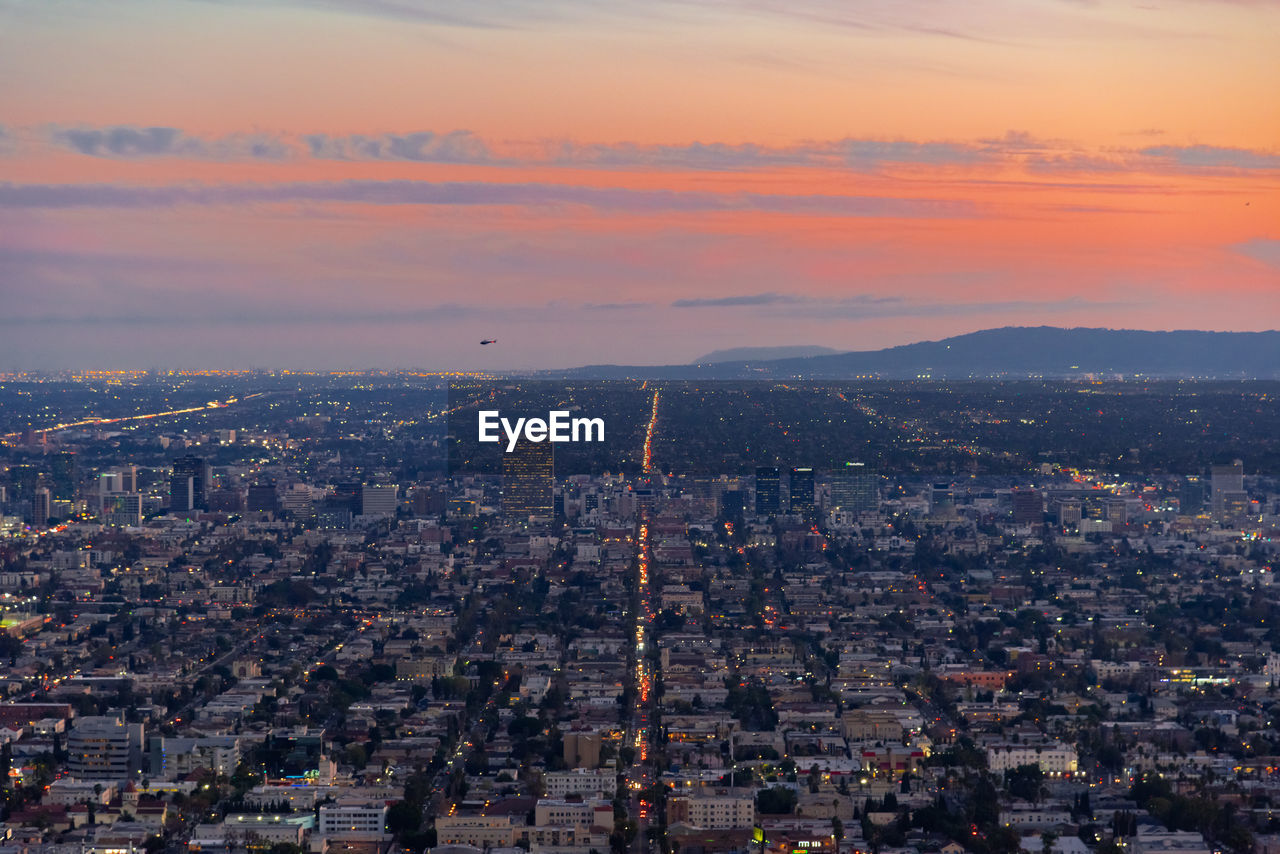 High angle view of city buildings during sunset