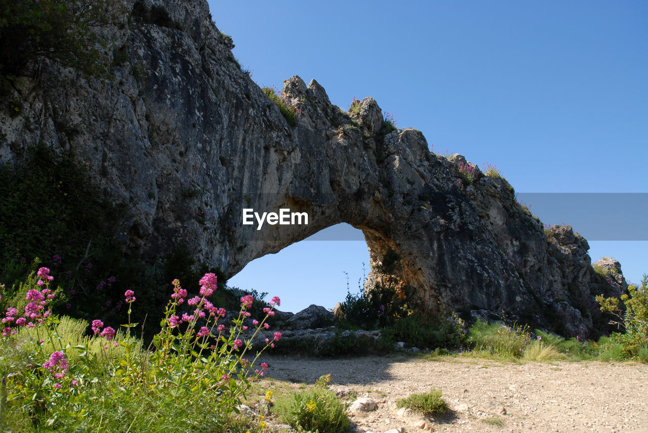 GROUP OF PEOPLE ON ROCK FORMATION