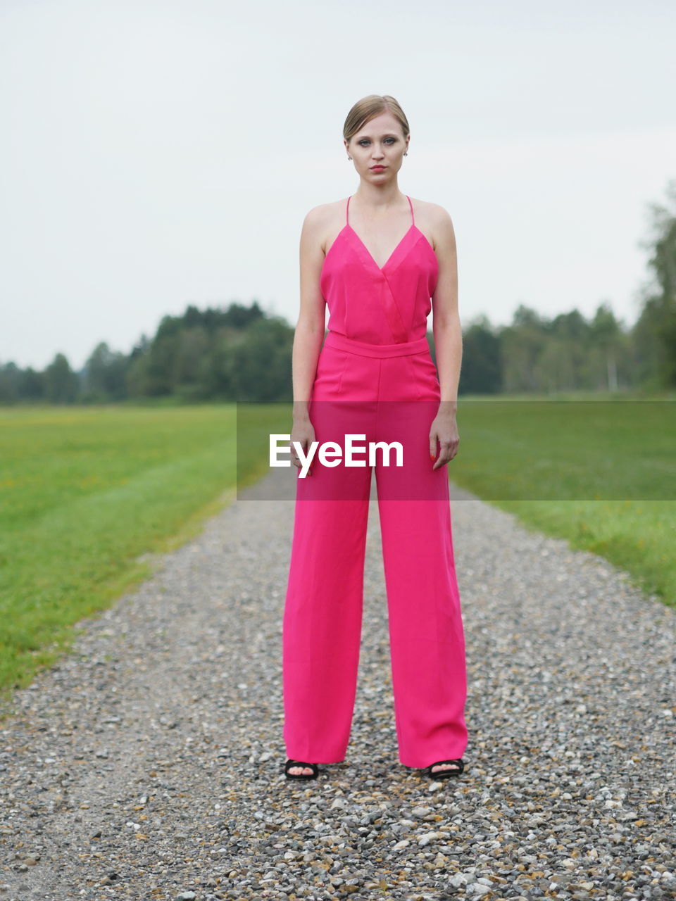 full length of young woman standing on road