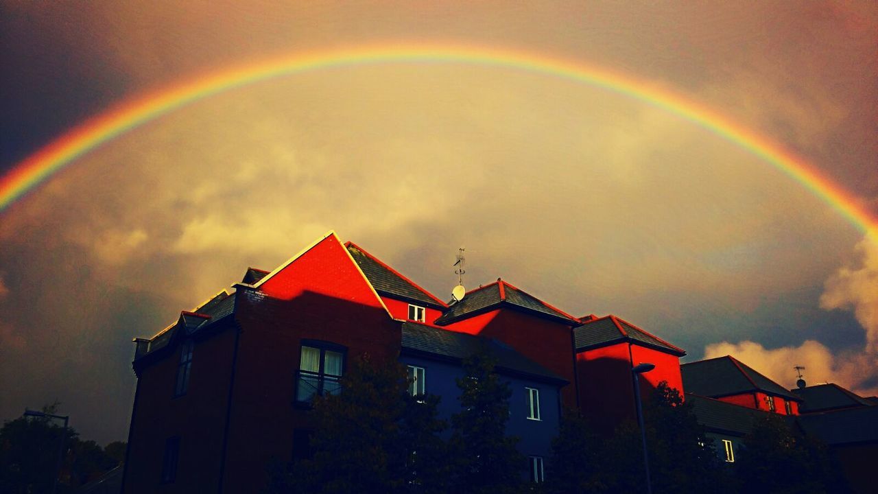 LOW ANGLE VIEW OF RAINBOW OVER BUILDING