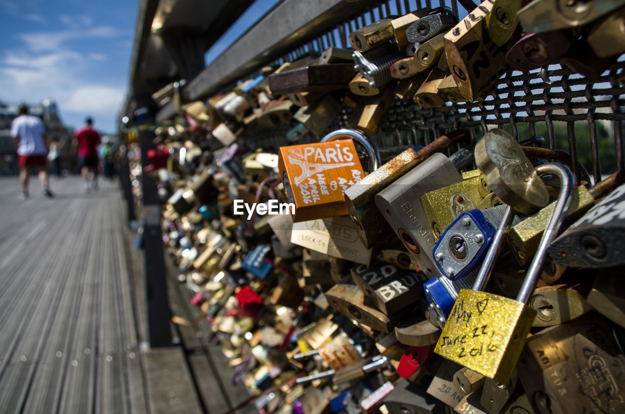 CLOSE-UP OF LOVE PADLOCKS ON RAILING