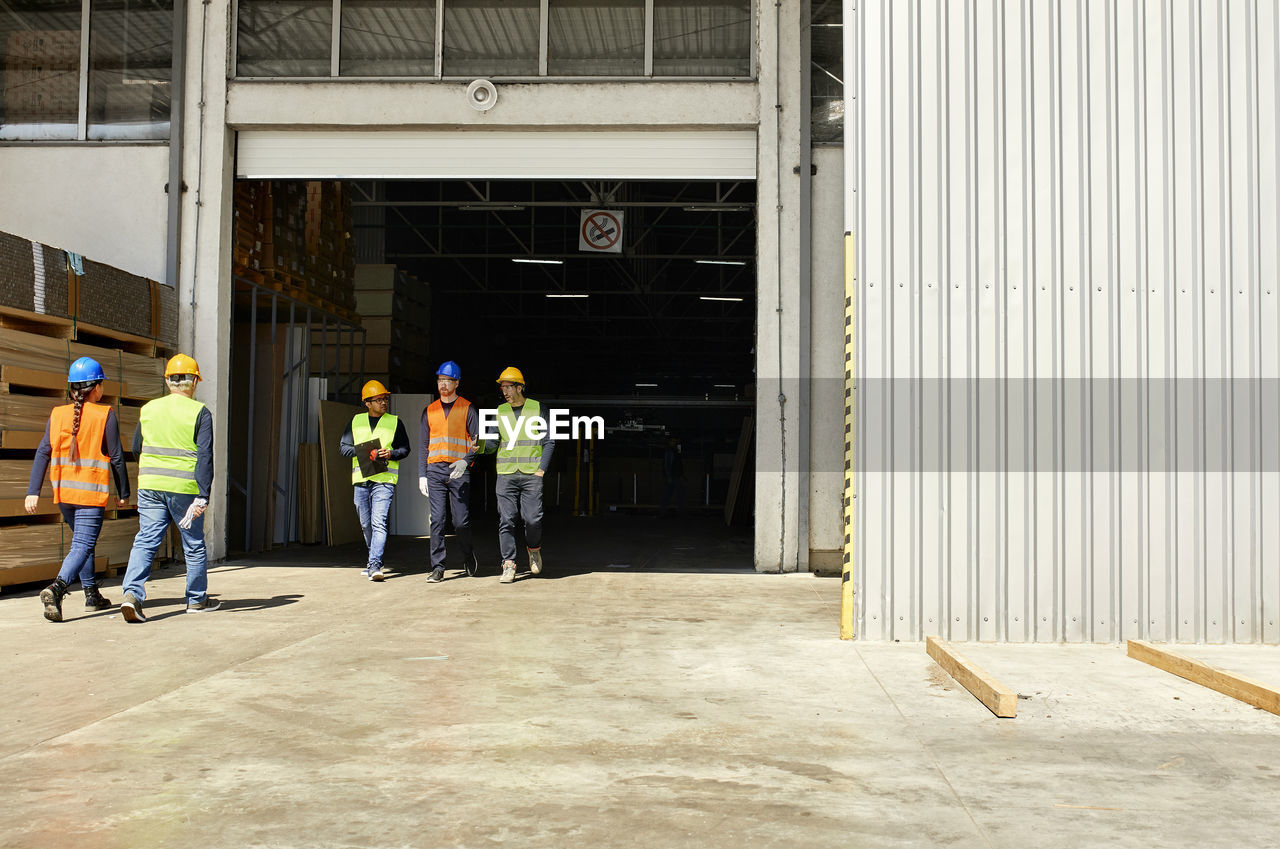 Group of workers walking on factory yard