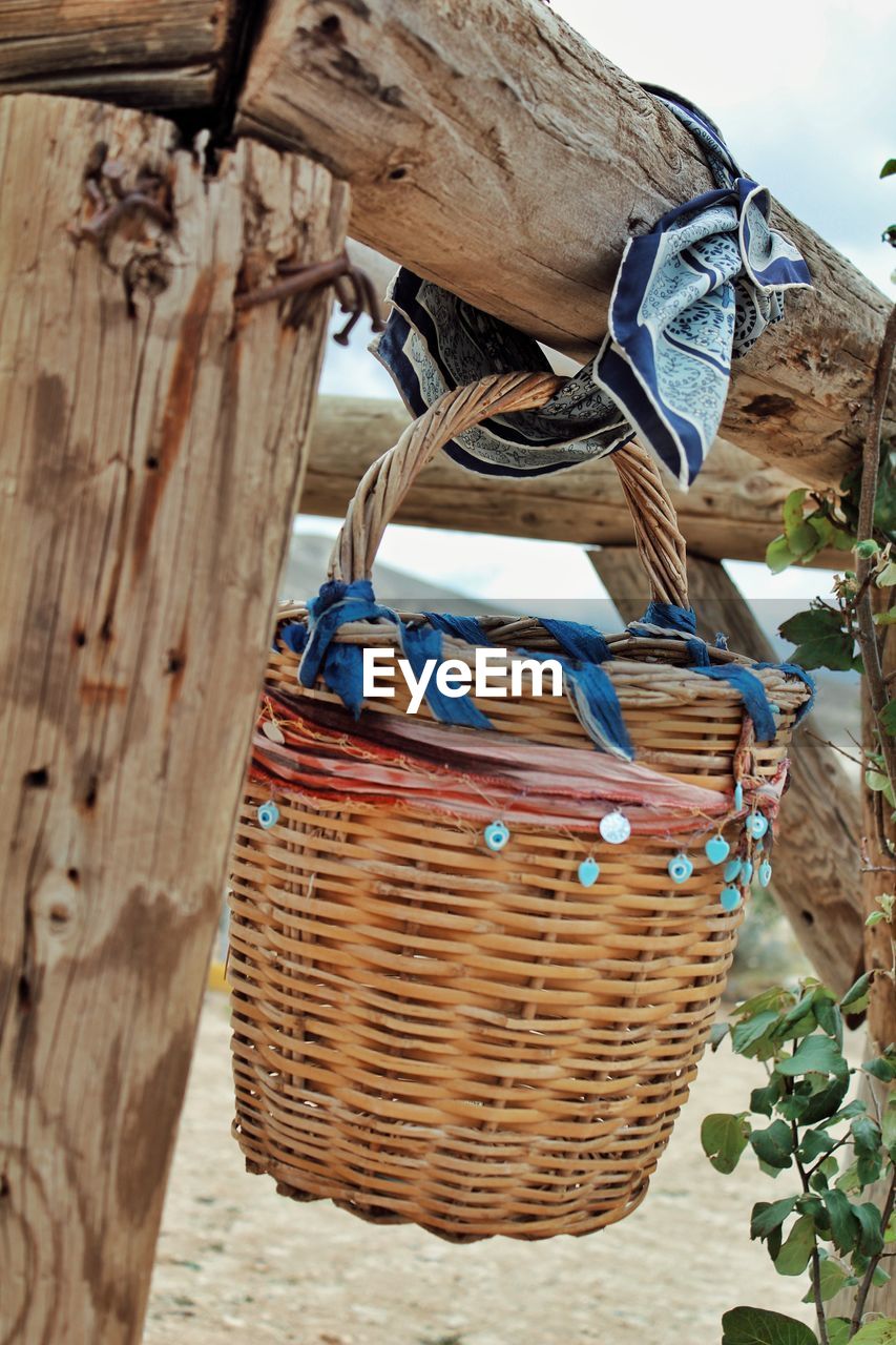 midsection of person holding wicker basket